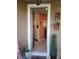 Open front door and stylish entryway features an orange accent wall and decor at 1134 Forest Gate Cir, Haines City, FL 33844