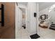Hallway with a sliding barn door and open doorway to a powder room at 1134 Forest Gate Cir, Haines City, FL 33844