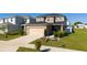 Landscaped yard frames the front exterior of this tan two-story house at 1134 Forest Gate Cir, Haines City, FL 33844