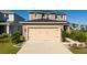Two-story home featuring a two-car garage and well-maintained landscaping at 1134 Forest Gate Cir, Haines City, FL 33844