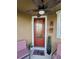 Charming front porch with a ceiling fan and decorated with chairs and seasonal decor at 1134 Forest Gate Cir, Haines City, FL 33844