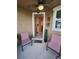 Cozy front porch furnished with outdoor seating and decorative plants, inviting entrance at 1134 Forest Gate Cir, Haines City, FL 33844