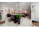 Open-concept kitchen island with modern pendant lighting and ample storage at 1134 Forest Gate Cir, Haines City, FL 33844