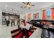 Inviting living room featuring a plush sofa and seamless kitchen view at 1134 Forest Gate Cir, Haines City, FL 33844