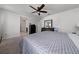 Well-lit main bedroom with a bed, dresser, and a ceiling fan, showcasing a comfortable and relaxing space at 1134 Forest Gate Cir, Haines City, FL 33844