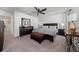 Spacious main bedroom featuring a dark wood dresser, ceiling fan, and relaxing decor at 1134 Forest Gate Cir, Haines City, FL 33844