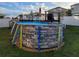Backyard pool with deck and pool cover, ready for relaxation and summer fun at 1134 Forest Gate Cir, Haines City, FL 33844