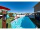 Above-ground pool is surrounded by a wooden deck, chairs, and an umbrella, creating a relaxing backyard space at 1134 Forest Gate Cir, Haines City, FL 33844