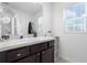 Bathroom with vanity, large mirror and window at 1330 Blazing Star Ln, Davenport, FL 33837