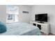 Bright bedroom with a TV and window coverings at 1330 Blazing Star Ln, Davenport, FL 33837