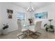 Modern dining room with glass table, white chairs, and a chandelier at 1330 Blazing Star Ln, Davenport, FL 33837
