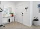Bright entryway with glass-top console table, mirror, and potted plants at 1330 Blazing Star Ln, Davenport, FL 33837