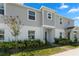 Two-story townhome with gray siding, landscaping, and a brick walkway at 1330 Blazing Star Ln, Davenport, FL 33837