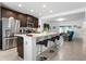 Modern kitchen with island, dark cabinets, and stainless steel appliances at 1330 Blazing Star Ln, Davenport, FL 33837