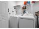 Laundry room with washer, dryer, and shelving at 1330 Blazing Star Ln, Davenport, FL 33837