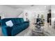 Open concept living room with blue sofa and view of kitchen at 1330 Blazing Star Ln, Davenport, FL 33837