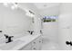 Bathroom featuring a large mirror above double sinks and a shower-tub combo for functional elegance at 840 Coach Lamp Ct, Sanford, FL 32771