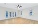 Bright bedroom with white walls, wood floors, ceiling fan, and French doors for a modern, airy feel at 840 Coach Lamp Ct, Sanford, FL 32771