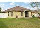 Well-maintained backyard and rear exterior of the home featuring an awning at 2703 Gullane Ct, Kissimmee, FL 34746