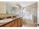 Bathroom with a double sink vanity, tub, walk-in shower and large mirror at 2703 Gullane Ct, Kissimmee, FL 34746