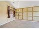 Bright bedroom featuring a stylish pendant light, custom wall trim, and neutral carpeting at 2703 Gullane Ct, Kissimmee, FL 34746