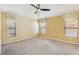 Serene bedroom featuring carpet flooring, neutral walls, and ample natural light from multiple windows at 2703 Gullane Ct, Kissimmee, FL 34746