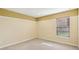 Bedroom featuring carpeted floors, a large window, and tan paint at 2703 Gullane Ct, Kissimmee, FL 34746