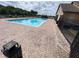 Sparkling community pool with brick paver decking, and accessible lounge area for residents at 2703 Gullane Ct, Kissimmee, FL 34746