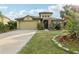 Charming single-Gathering home with a well-maintained lawn, stone accents, and a two-car garage at 2703 Gullane Ct, Kissimmee, FL 34746