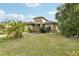 A beautifully landscaped home with stone details, a well-kept lawn, and tropical foliage at 2703 Gullane Ct, Kissimmee, FL 34746