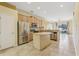 Open kitchen layout with stainless steel appliances, wood cabinets, and tile flooring at 2703 Gullane Ct, Kissimmee, FL 34746