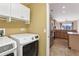 Bright laundry room featuring white washer and dryer and plenty of storage with cabinets at 2703 Gullane Ct, Kissimmee, FL 34746