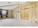 Open living room featuring neutral carpet, tall columns, and a decorative pendant light at 2703 Gullane Ct, Kissimmee, FL 34746