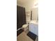 Modern bathroom boasts sleek vanity, shelving and a shower with a stylish black curtain at 6016 Westgate Dr # 301, Orlando, FL 32835