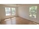 Sunlit bedroom boasts beautiful hardwood floors and a view of lush green foliage at 6016 Westgate Dr # 301, Orlando, FL 32835