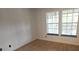 Cozy bedroom features natural light from the double windows and sleek wood flooring at 6016 Westgate Dr # 301, Orlando, FL 32835