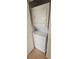 Compact laundry closet featuring a stacked washer and dryer unit for space-saving convenience at 6016 Westgate Dr # 301, Orlando, FL 32835
