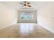 Light-filled bedroom with large window and tile floors at 676 Villa Park Rd, Kissimmee, FL 34759