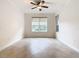 Bright bedroom with large window and ceiling fan at 676 Villa Park Rd, Kissimmee, FL 34759