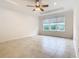 Bright and airy bedroom with large window and ceiling fan at 676 Villa Park Rd, Kissimmee, FL 34759