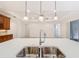 Kitchen island with double sink and modern faucet at 676 Villa Park Rd, Kissimmee, FL 34759