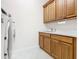 Laundry room with cabinets, sink, and washer/dryer hookups at 676 Villa Park Rd, Kissimmee, FL 34759