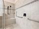 Walk-in shower with tiled walls and built-in seat at 676 Villa Park Rd, Kissimmee, FL 34759