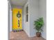 Close-up of the front door with its bright yellow color and charming wreath, creating a welcoming entrance at 3200 Songbird Cir, Harmony, FL 34773