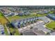 Aerial view of townhomes surrounded by lush landscaping and a tranquil lake in a desirable community at 3359 Bellezza Ct, Kissimmee, FL 34746