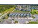 Aerial view of townhomes surrounded by lush landscaping and a tranquil lake in a desirable community at 3359 Bellezza Ct, Kissimmee, FL 34746