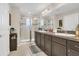 Primary bathroom featuring double sinks, ample cabinet space, and a glass enclosed shower at 3359 Bellezza Ct, Kissimmee, FL 34746