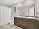 Bathroom featuring double sinks, ample counter space, and a shower and tub combo at 3359 Bellezza Ct, Kissimmee, FL 34746