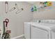 A functional laundry room featuring a washer, dryer and built in storage at 3359 Bellezza Ct, Kissimmee, FL 34746