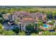 Stunning aerial view of the property with a pool, well-maintained landscaping, and beautiful architecture at 500 Mirasol Cir # 105, Celebration, FL 34747